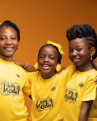 Young child model learning confidence and posing with DXC Models in Lagos Nigeria